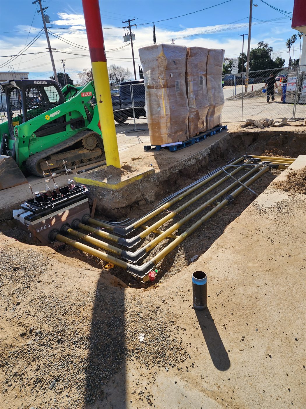 Fuel piping routed through a prepared trench near station equipment
