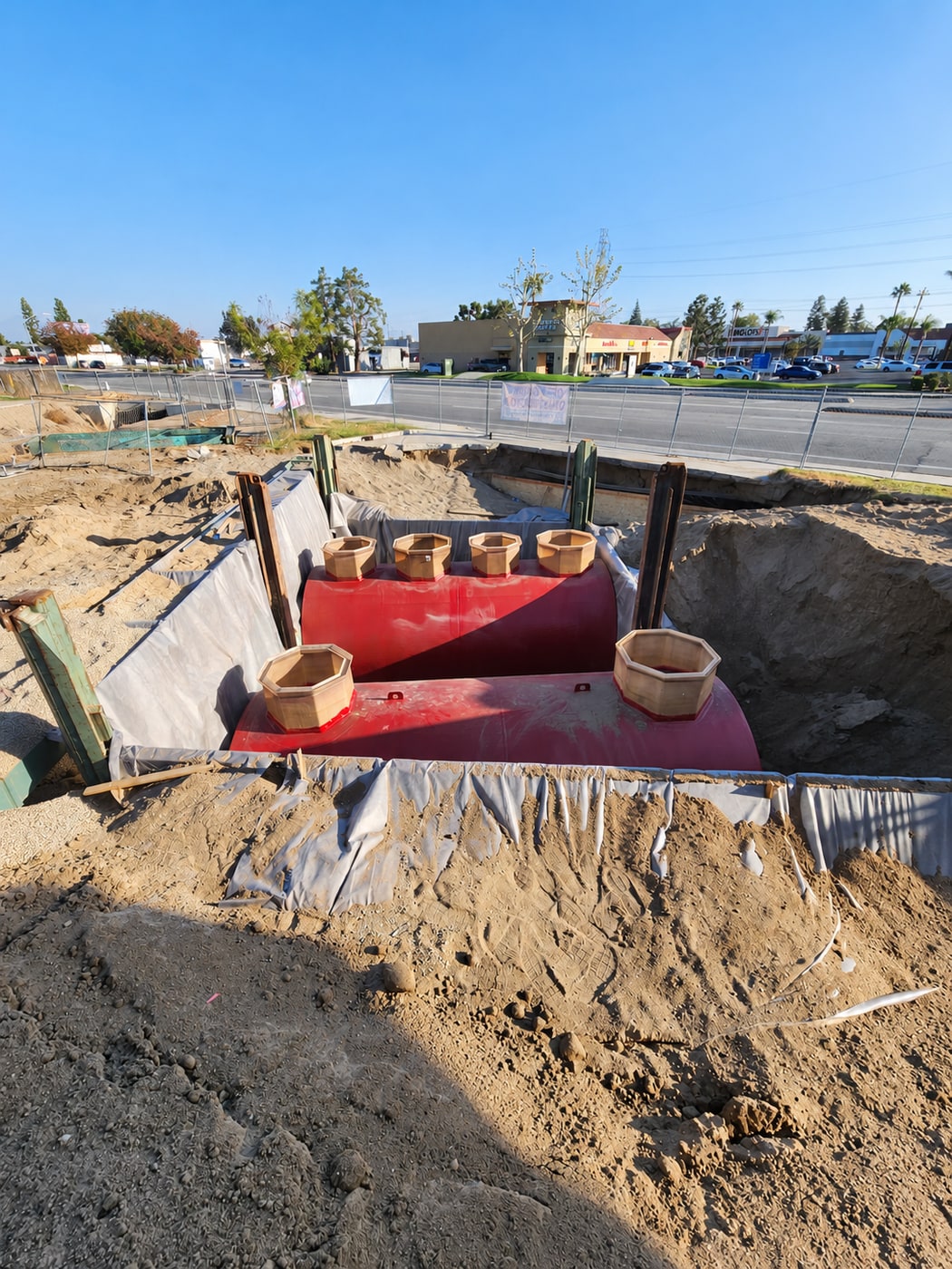 Two new underground fuel tanks positioned inside a shored excavation